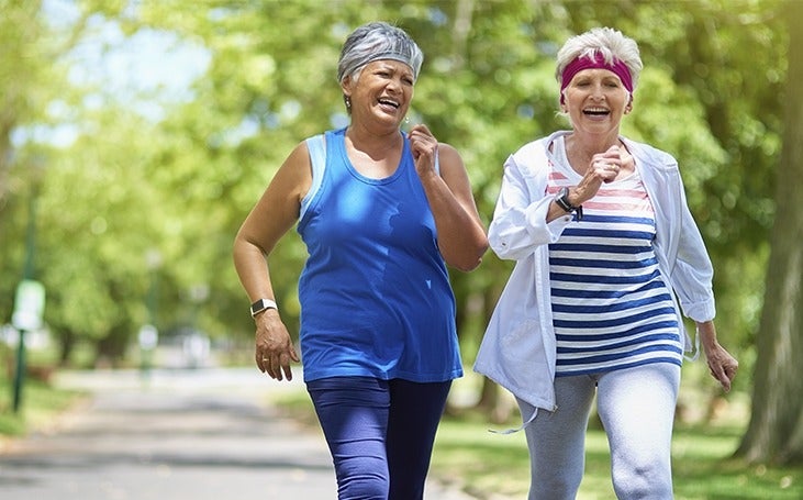 Two women walking together and laughing