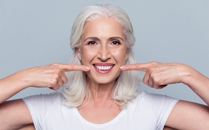 Woman pointing to her teeth